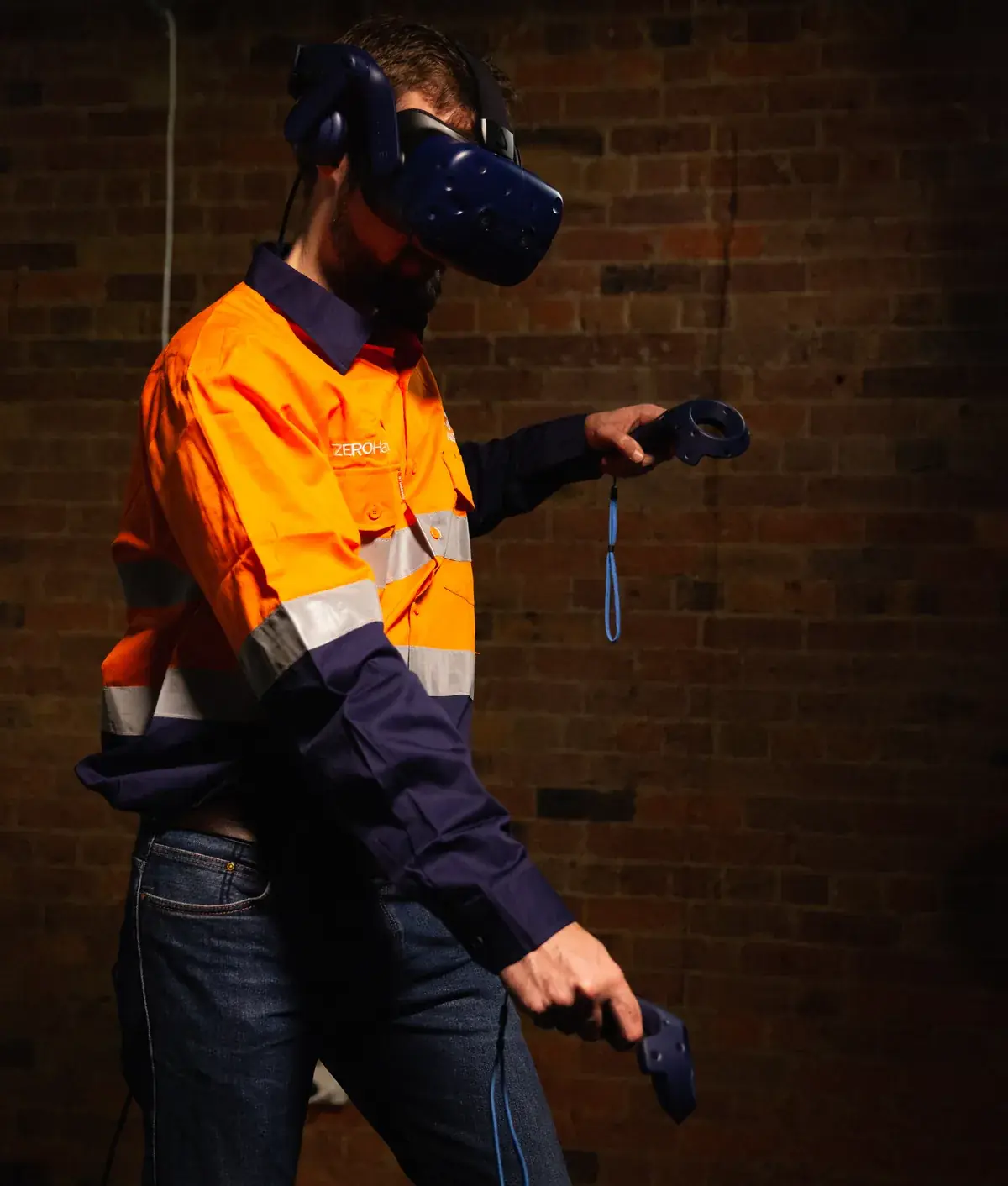 A trainee in hi-vis using a VR headset