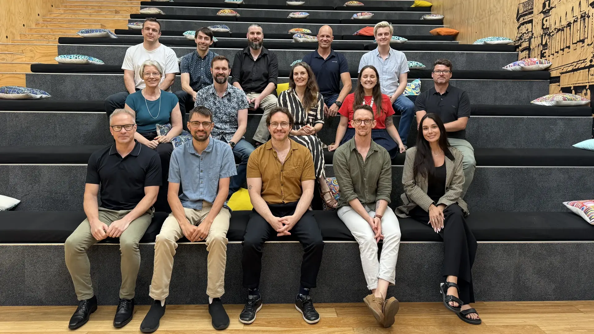 The Nexefy team sitting together on the steps at The Precinct in Fortitude Valley