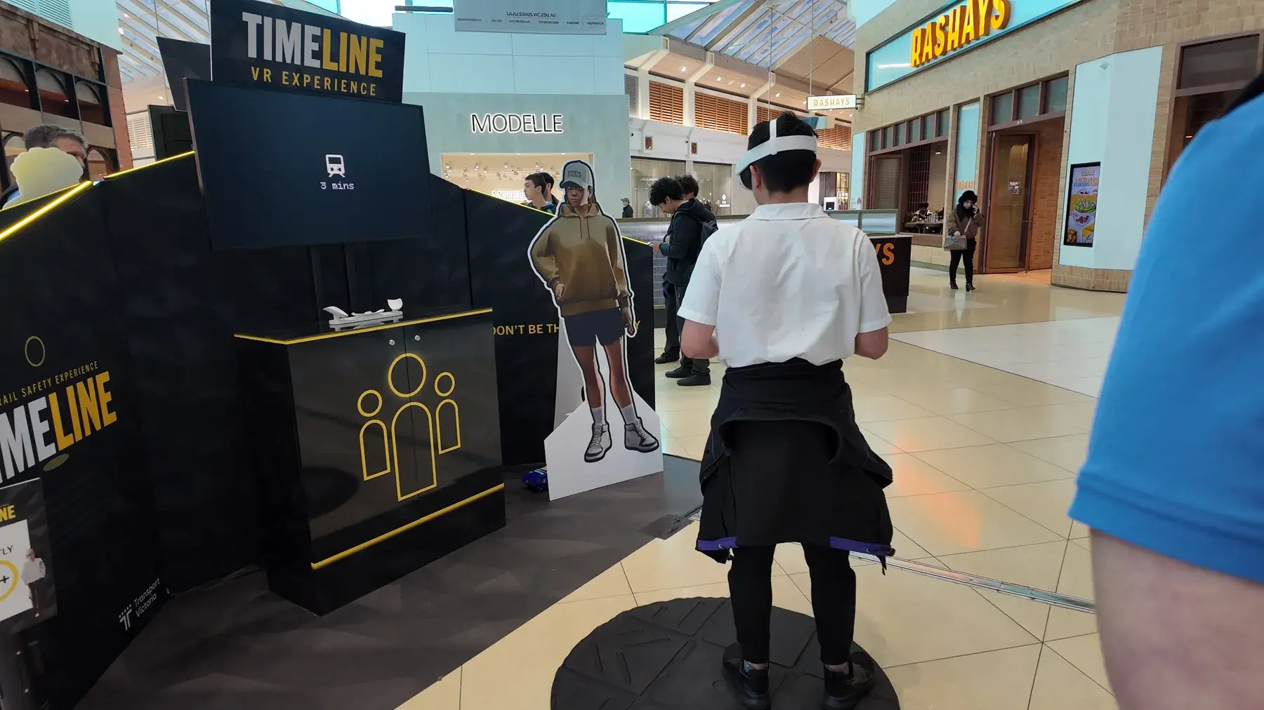 A young person playing Timeline at a community booth